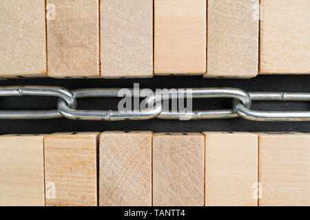 Wooden blocks and chain. Cryptocurrency blockchain abstract concept. Stock Photo