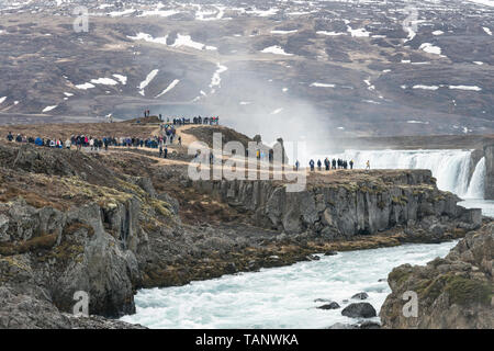 Crowds of tourists at Goðafoss waterfall, north Iceland. Mass tourism is becoming a significant problem even in the remoter parts of the country Stock Photo