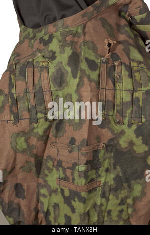 A lace-up shirt M 42, 1st type reversible design in oak leaf camouflage Made of reversible tent cloth, printed in spring and autumn colours, with the same fittings on both sides: reinforced eyelet placket on the upper half, the five eyelet pairs edged using an eyelet buttonhole sewing machine. Straight hip pockets with pocket linings of field-grey drill cloth, the upper flaps fastened with bowl-shaped buttons known as Napfknöpfe. Several sets of three fastening loops each sewn on the upper body, for camouflage material. Elastic bands inserted just below waist height and in , Editorial-Use-Only Stock Photo