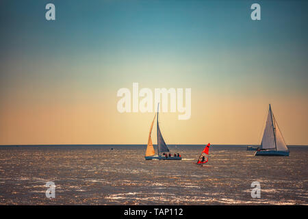 Sailing ship yacht with white sails in the sea. Stock Photo