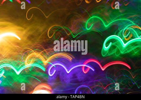 Glowing multicolored wavy lines similar as sea waves. Neon seamless luminous background. Photographic effect of long exposure. Stock Photo