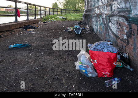 Rubbish left behind a wall under a bridge by the River Trent, West Bridgford, Nottinghamshire, England, UK Stock Photo