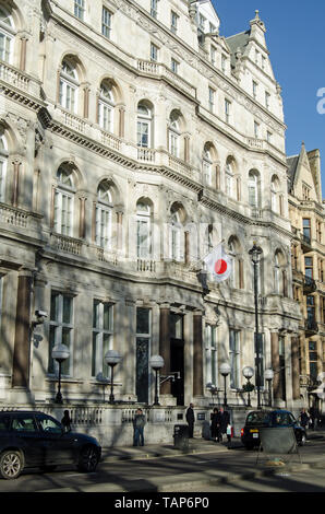 LONDON, UK - JANUARY 28, 2016:  Traffic and pedestrians passing the Embassy of Japan on Piccadilly, London. Stock Photo