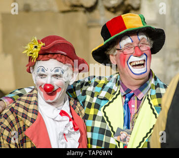 LONDON, UK - FEBRUARY 7, 2016:  Two clowns sharing a joke ahead of the annual church service in memory of Joseph Grimaldi held at All Saints Church in Stock Photo