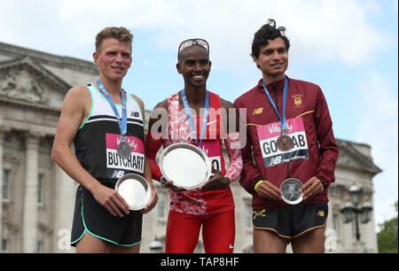 Sir Mo Farah (centre) celebrates winning the Men's Elite Race alongside second placed Andy Butchart (left) and third placed Nick Goolab during the Vitality London 10,000. Stock Photo
