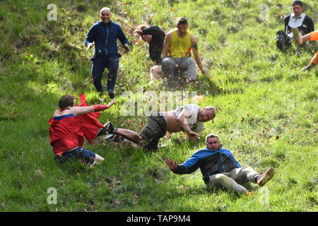 Participants take part in the annual cheese rolling competition at Cooper's Hill in Brockworth, Gloucestershire. Stock Photo
