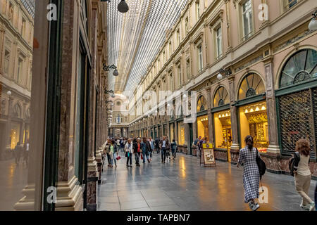 People walking through  Les Galeries Royales Saint-Hubert , an elegant glazed shopping arcade in Brussels ,Belgium Stock Photo