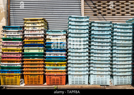 BANGKOK, THAILAND - MARCH 2019: piles of empty plastic crates at the market street. Stock Photo