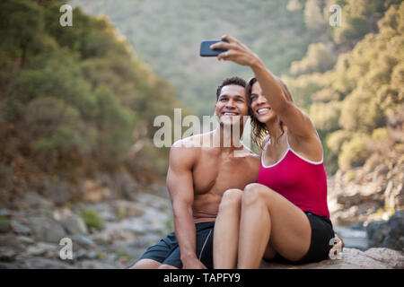 Smiling young couple posing for a self portrait. Stock Photo