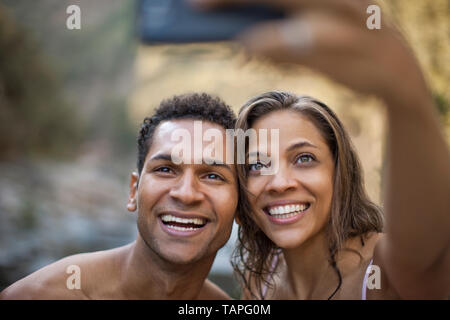 Smiling young couple posing for a self portrait. Stock Photo