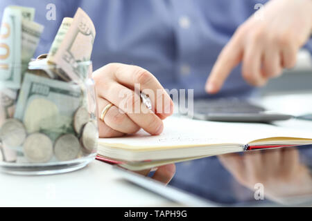 Male hand using calculator counting financial expenses Stock Photo