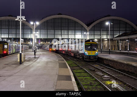 A First Transpennine Express class 185 at Hull Paragon station waiting to depart with a early morning train with Northern Rail pacer trains alongside Stock Photo