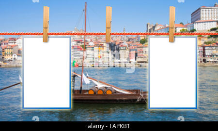 Blank photos hanging on clothesline with with Oporto defocused background (Portugal) - concept image Stock Photo