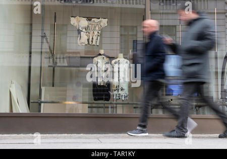 Berlin, Germany. 05th May, 2019. Two men walk past a fashion store. Credit: Paul Zinken/dpa/Alamy Live News Stock Photo