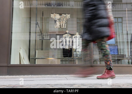 Berlin, Germany. 05th May, 2019. A woman walks past a fashion store. Credit: Paul Zinken/dpa/Alamy Live News Stock Photo