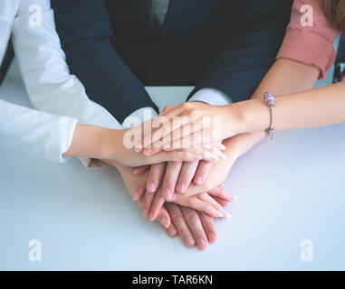 Office people putting hand together for business team success concept Stock Photo