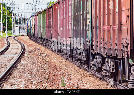 Long freight train approaches to the station. Stock Photo