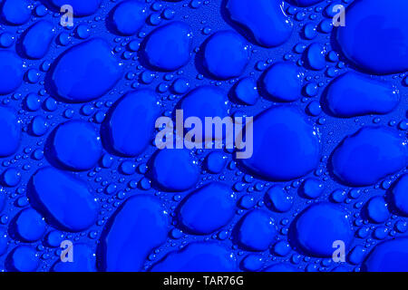 Transparent still water drops on light blue background. Blue water drops. Drops of rain on glass. Blue abstract water drop background. Water surface Stock Photo