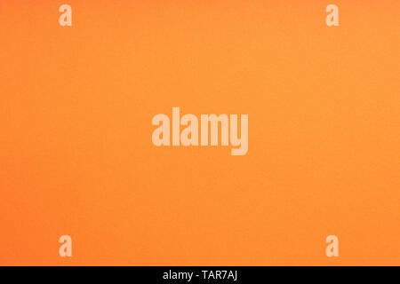 Paper background orange color. Rough paper texture. Closeup. Macro Stock Photo