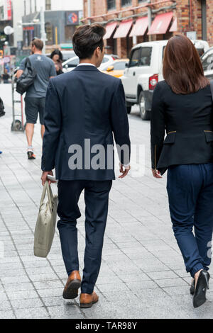 Business executives walking on sidewalk, Seoul, South Korea Stock Photo