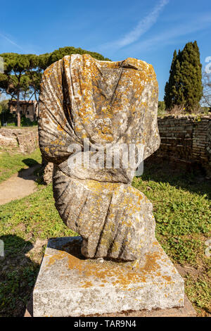Ancient roman statue with tunic in Ostia Antica, Roman colony founded in the 7th century BC. Rome, UNESCO world heritage site, Italy, Europe