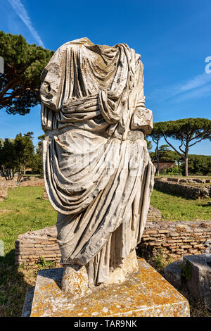 Ancient roman statue with tunic in Ostia Antica, Roman colony founded in the 7th century BC. Rome, UNESCO world heritage site, Italy, Europe