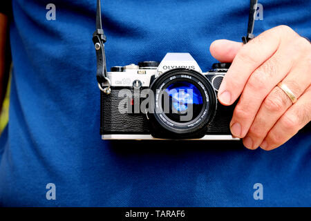 An Olympus OM10 SLR. A popular pre digital camera this old model is fitted with a Sigma lens