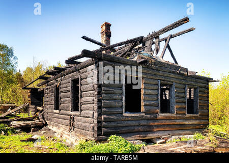Ruins of a burned down old wooden hut wide angle view Stock Photo