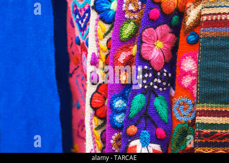 Peruvian traditional colourful native handicraft textile fabric at market in Machu Picchu, one of the New Seven Wonder of The World, Cusco Region Peru, South America. Stock Photo