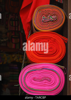 Peruvian traditional colourful native handicraft textile fabric at market in Machu Picchu, one of the New Seven Wonder of The World, Cusco Region Peru Stock Photo