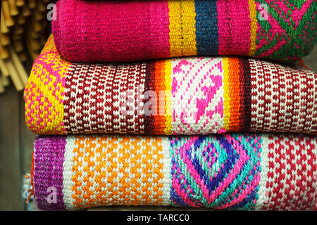 Peruvian traditional colourful native handicraft textile fabric at market in Machu Picchu, one of the New Seven Wonder of The World, Cusco Region Peru, South America. Stock Photo