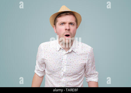 Young surprised man standing with open mouth. Stock Photo