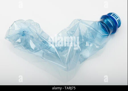 Plastic garbage theme. Blue plastic bottle crumpled isolated on white studio background Stock Photo