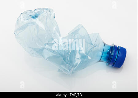 Crashed blue plastic bottle isolated on white studio background Stock Photo