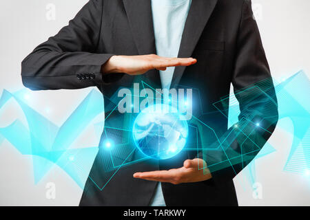 Businessman holding the glowing hologram digital globe. Concepr of business and innovation Stock Photo