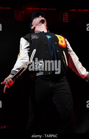 Rapper Logic is shown performing on stage during a live concert ...