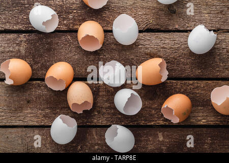 Empty egg shells on wooden background, top view Stock Photo