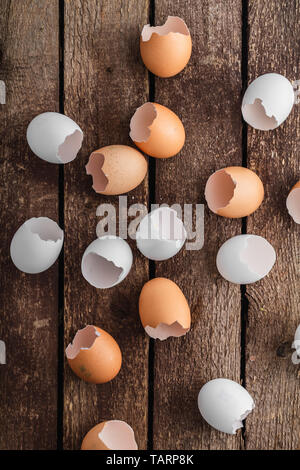 Empty egg shells on wooden background, top view Stock Photo