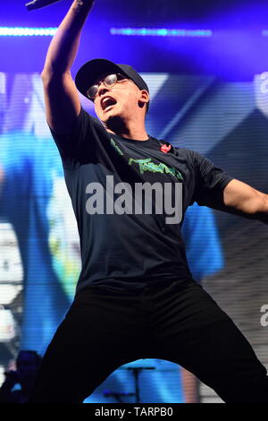 Rapper Logic is shown performing on stage during a live concert ...