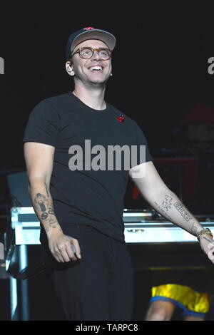 Rapper Logic is shown performing on stage during a live concert ...