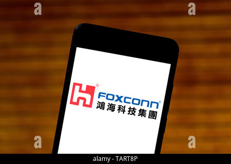 In this photo illustration the Hon Hai/Foxconn logo is seen displayed on a smartphone. Stock Photo