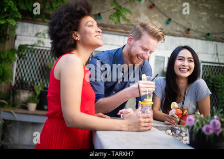 Multiracial group of friends having fun and talking Stock Photo