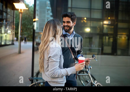 Beautiful young couple walking down the street with tablet Stock Photo