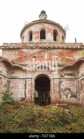 Ruins of old abandoned church. Building with collapsed vault is covered with broken bricks and overgrown grass and bushes. Church of the Nativity of C Stock Photo