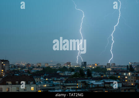 Lightning Thunderbolt Flash Strike Over City in the Night. Weather Concept. Stock Photo