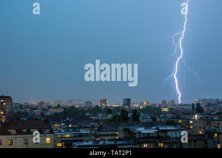 Lightning Thunderbolt Flash Strike Over City in the Night. Weather Concept. Stock Photo