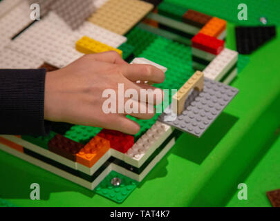 Child's hands building with Lego bricks Stock Photo