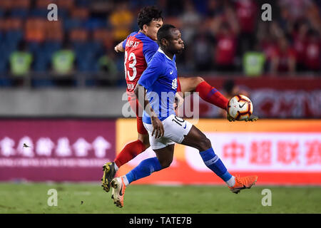 Cameroonian football player Christian Bassogog, right, of Henan Jianye passes the ball against a player of Chongqing SWM in their 11th round match during the 2019 Chinese Football Association Super League (CSL) in Chongqing, China, 24 May 2019.  Chongqing SWM played draw to Henan Jianye 0-0.
