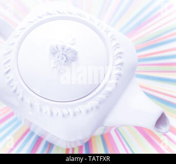 Antique teapot - luxury ceramic kettle on rainbow background Stock Photo