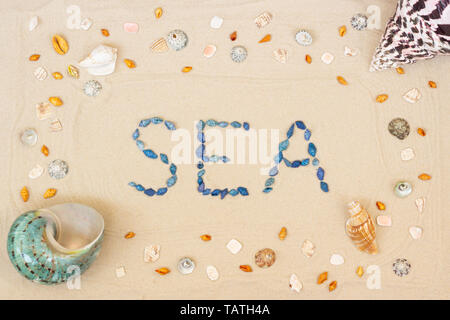 Sand on the beach in summer, the inscription from the shells on the sand. Close-up. Flat lay. Top view Stock Photo